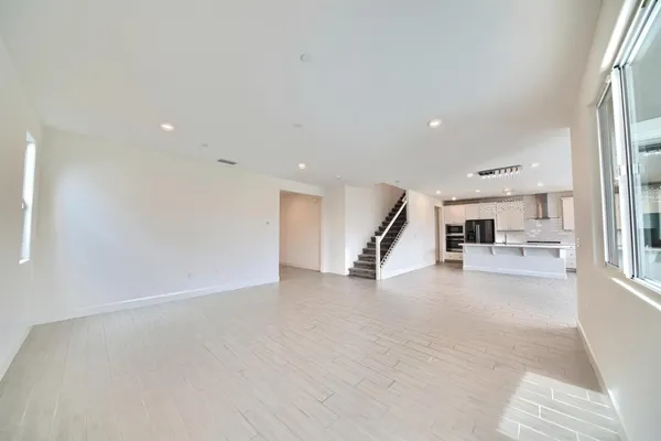 an empty room with a fireplace and windows