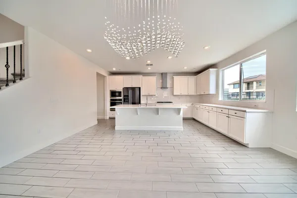 a large white kitchen with a large window