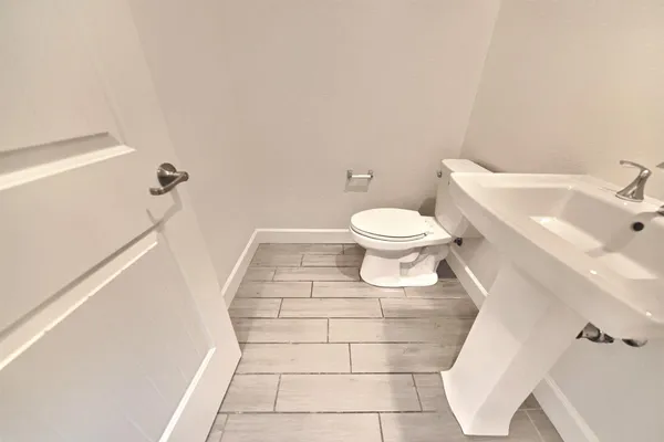a bathroom with a toilet and a sink
