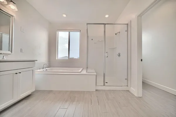 a bathroom with bathtub and window