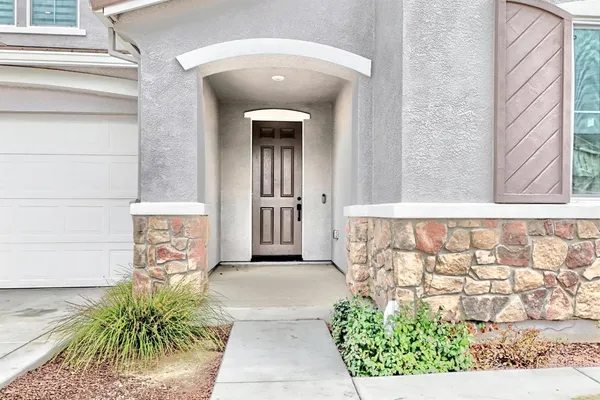 a front view of a house with plants