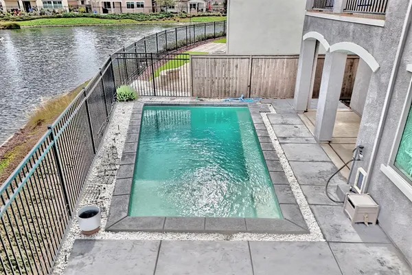 a view of an outdoor space pool patio lake and outdoor seating