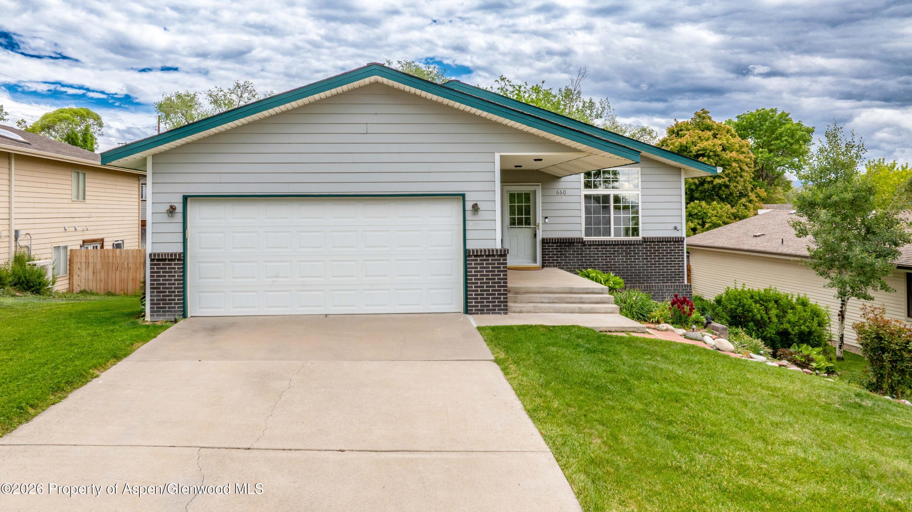 660 Aspen Avenue Rifle, CO 81650 - Photo 2 of 30 a front view of house with yard and green space