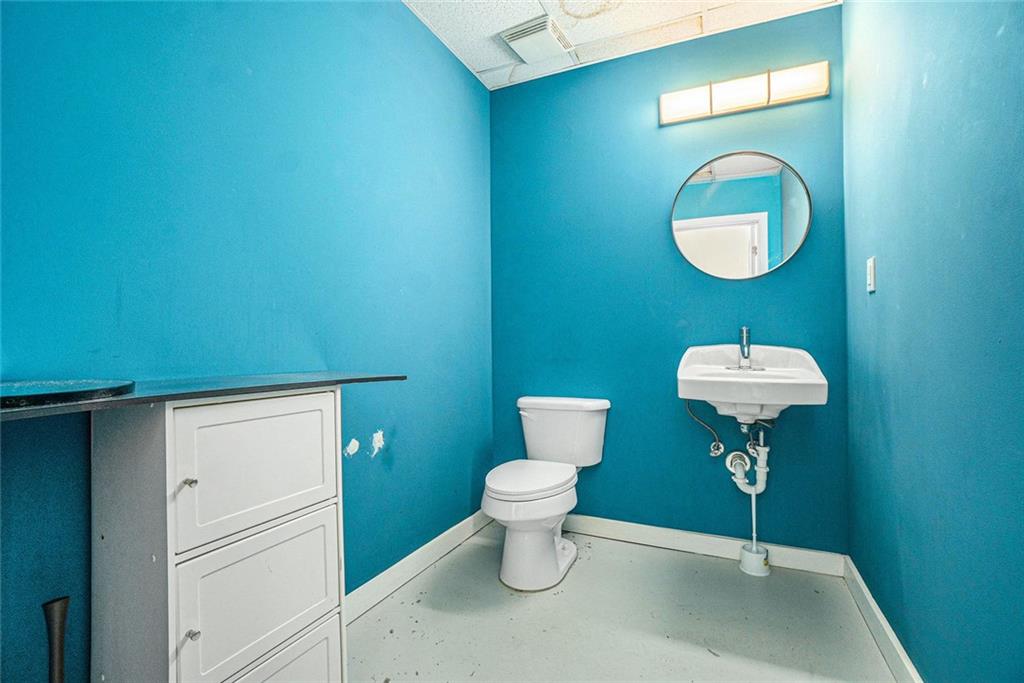 311 Nelson Street Southwest Atlanta, GA 30313 - Photo 5 of 27 a bathroom with a toilet a sink and a mirror