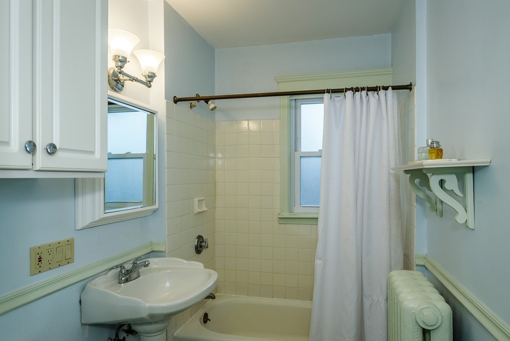 176 Manthorne Road, Unit 2 Boston, MA 02132 - Photo 14 of 16 a bathroom with a sink a toilet and shower
