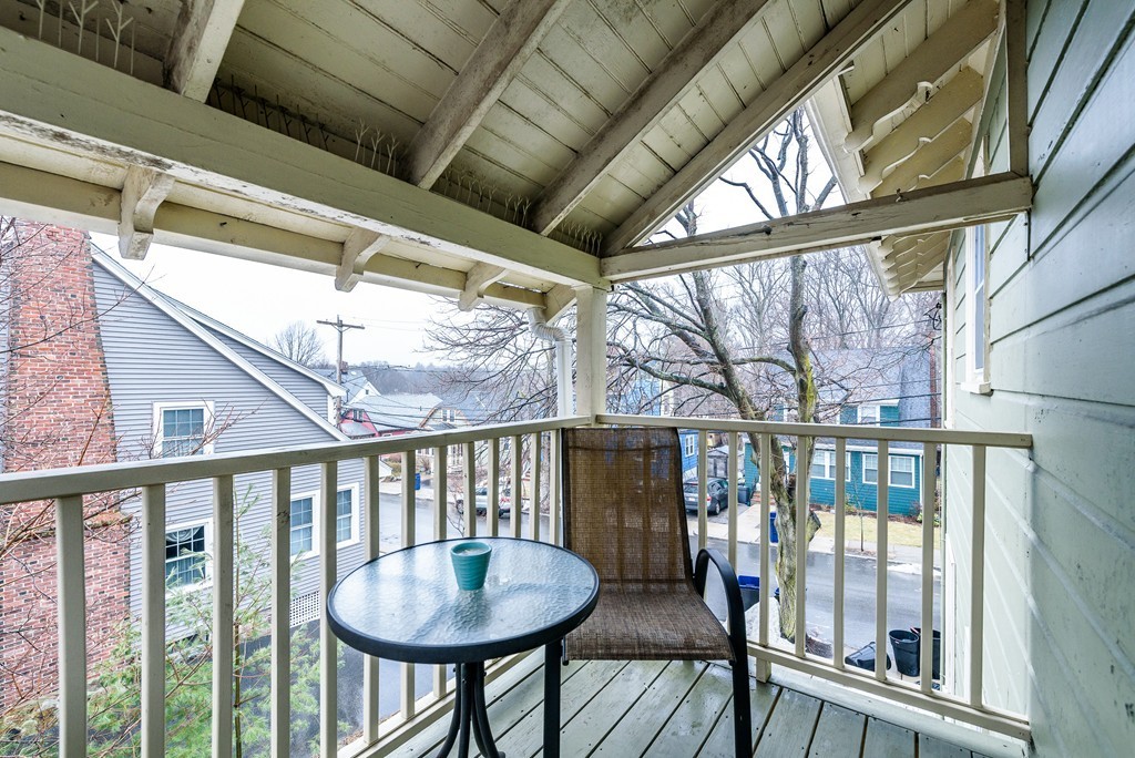 176 Manthorne Road, Unit 2 Boston, MA 02132 - Photo 15 of 16 a view of a porch with furniture and wooden floor