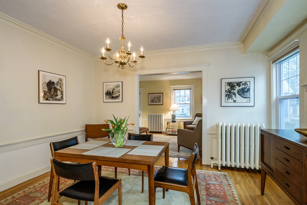 176 Manthorne Road, Unit 2 Boston, MA 02132 - Photo 2 of 16 a view of a dining room with furniture wooden floor and a chandelier