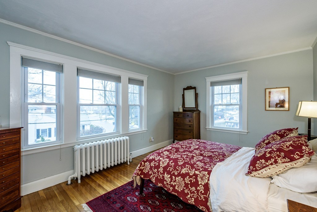 176 Manthorne Road, Unit 2 Boston, MA 02132 - Photo 9 of 16 a bedroom with a bed and a window