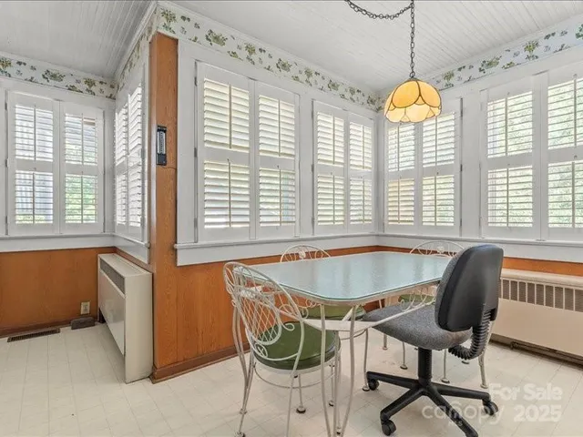 a dining room with furniture and window
