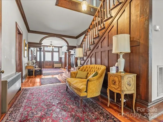 a spacious bedroom with a bed a fireplace and a large window