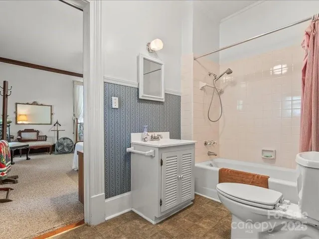 a living room with furniture a bookshelf and a large window