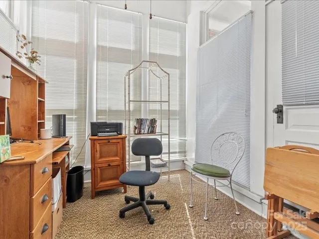 a living room with wooden floor furniture and a rug