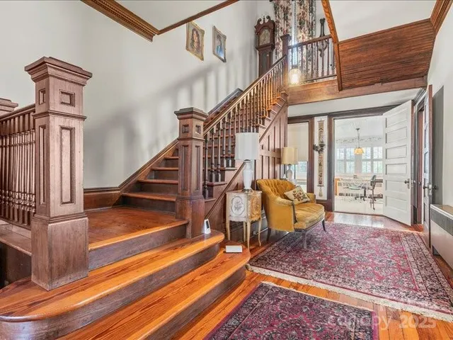 a view of a hallway with wooden floor and entryway
