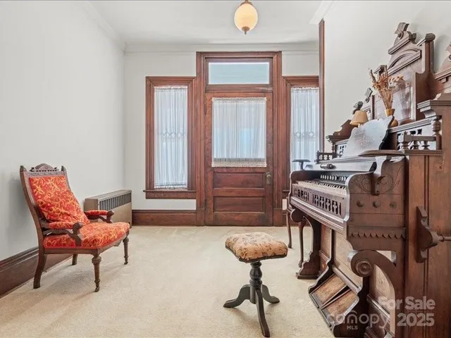 a view of empty room with fireplace and fan