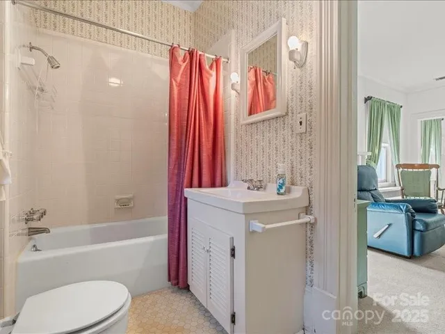 a living room with furniture a fireplace and a chandelier