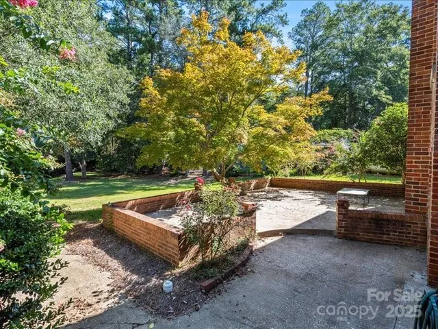 a view of a house with wooden fence