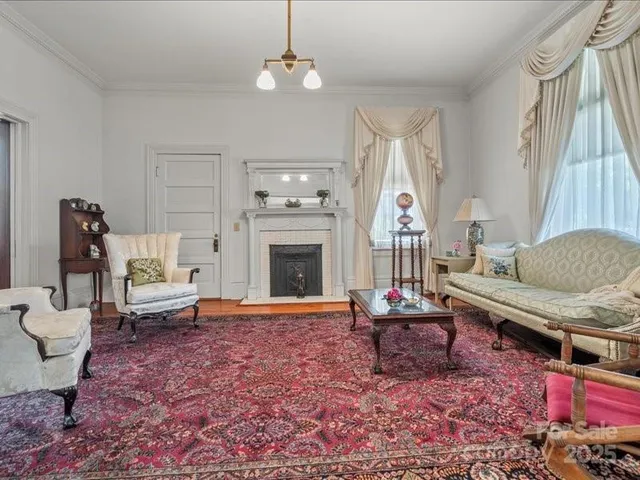 a living room with furniture a rug and a fireplace