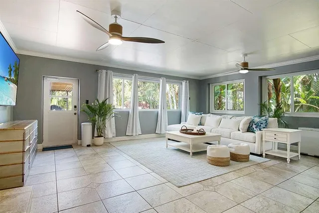 a living room with furniture and large windows