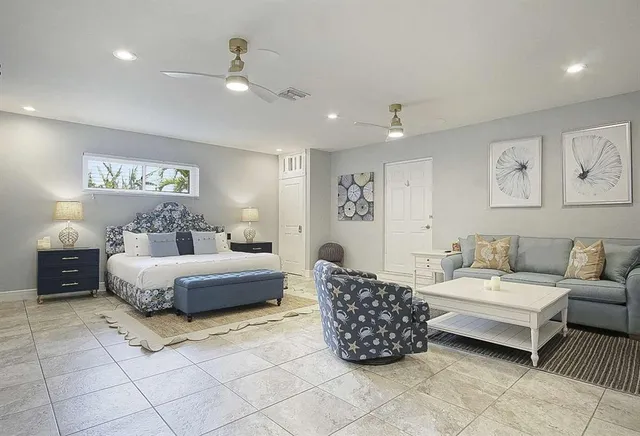 a spacious bedroom with a bed and a couch