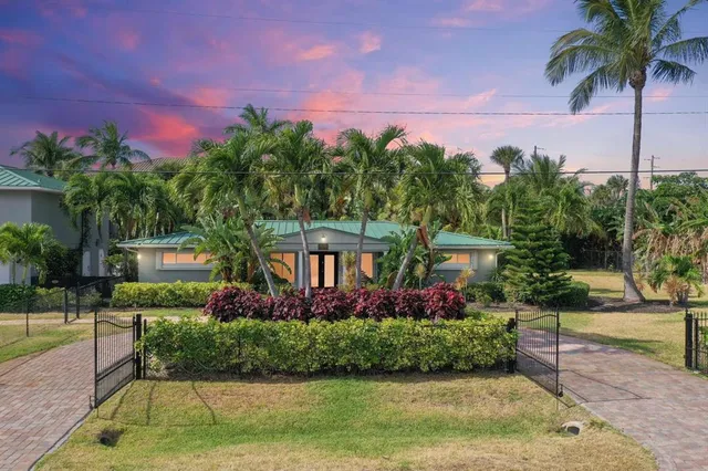 a front view of a house with a yard garage and outdoor seating