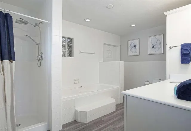 a bathroom with a bathtub and a shower