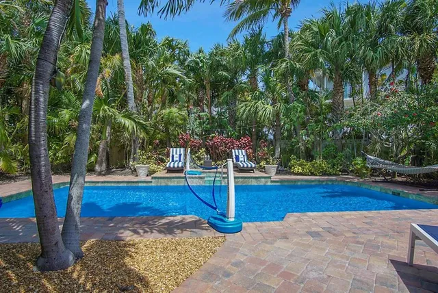 a view of a patio with a dining table and chairs with wooden floor