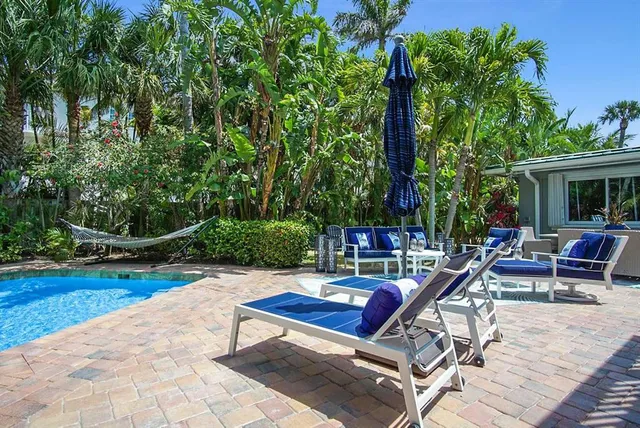 a backyard of a house with table and chairs