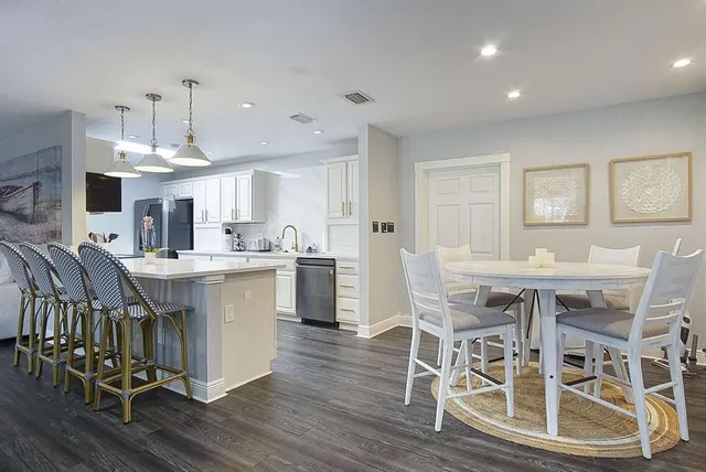 a view of a dining room with furniture wooden floor and chandelier