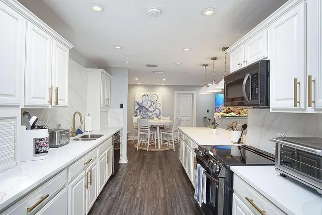 a kitchen with a sink stainless steel appliances and cabinets