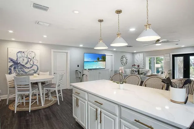 a large kitchen with a table and chairs