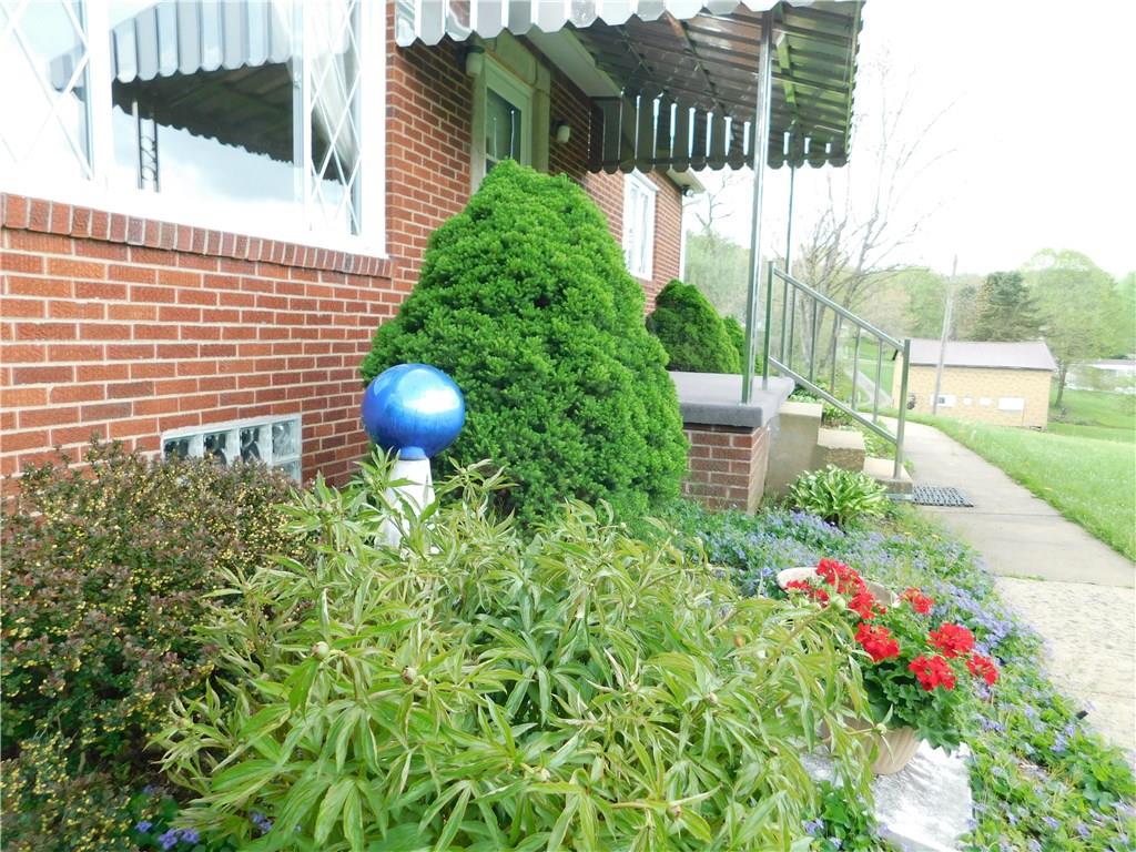 1086 White Cloud Road Apollo, PA 15613 - Photo 4 of 21 The flower beds are anchored by mature evergreens and feature flowering perennials.