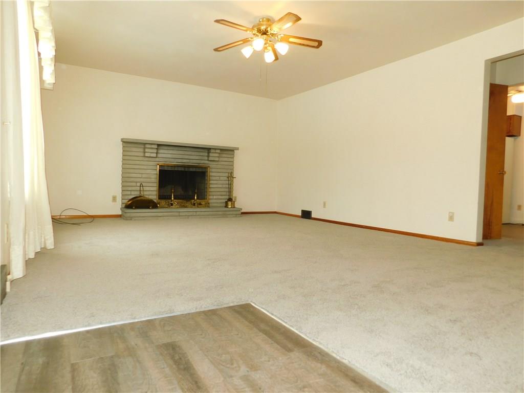 1086 White Cloud Road Apollo, PA 15613 - Photo 9 of 21 The spacious living room is anchored by a wood burning fireplace - display your favorite art piece above the stone mantle.