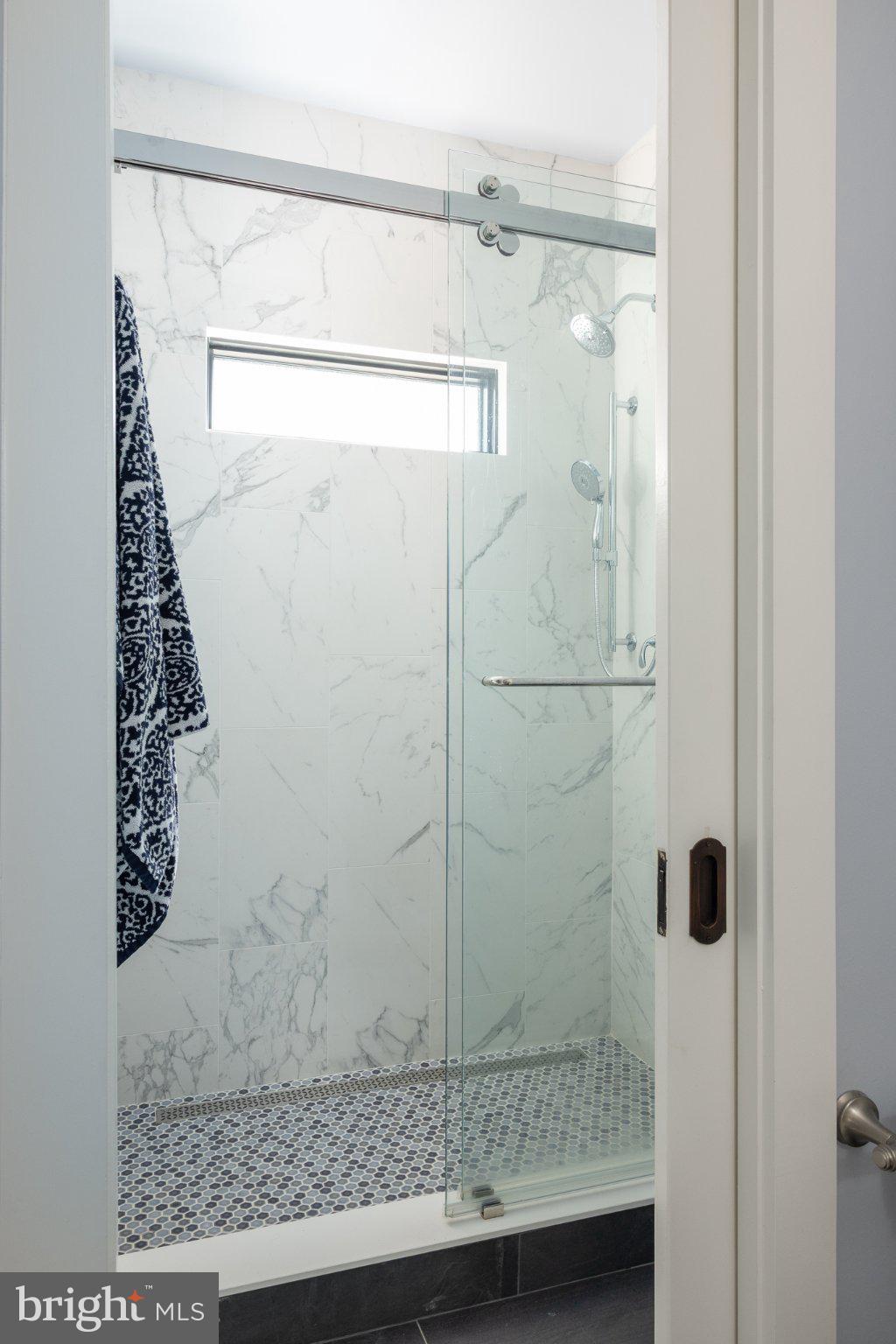 4905 16th Road North Arlington, VA 22207 - Photo 13 of 19 Sleek shower with elegant marble design.