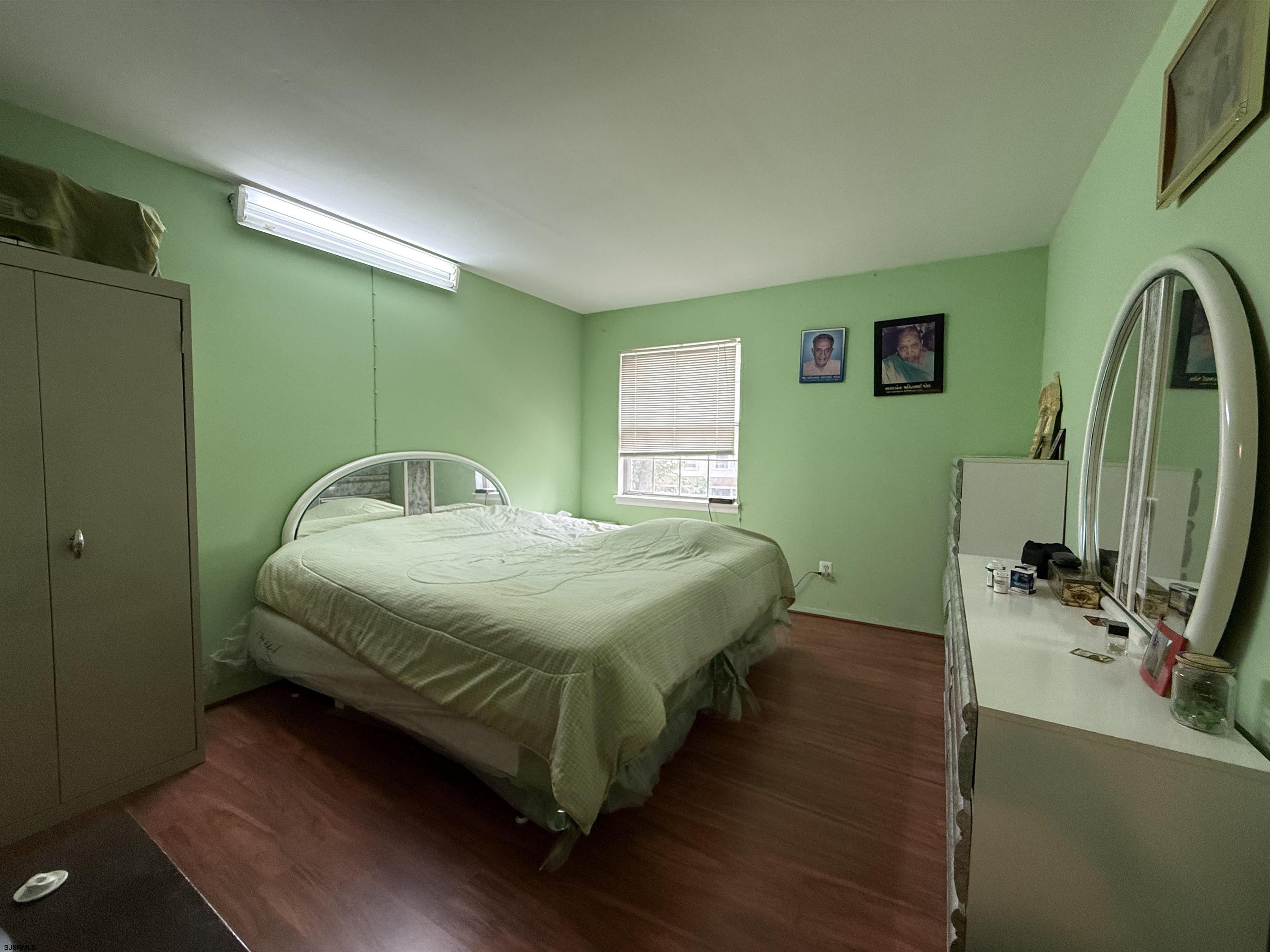 720 South New Road, Unit 5M Absecon, NJ 08201 - Photo 11 of 14 a bedroom with a bed and a flat tv screen on dresser