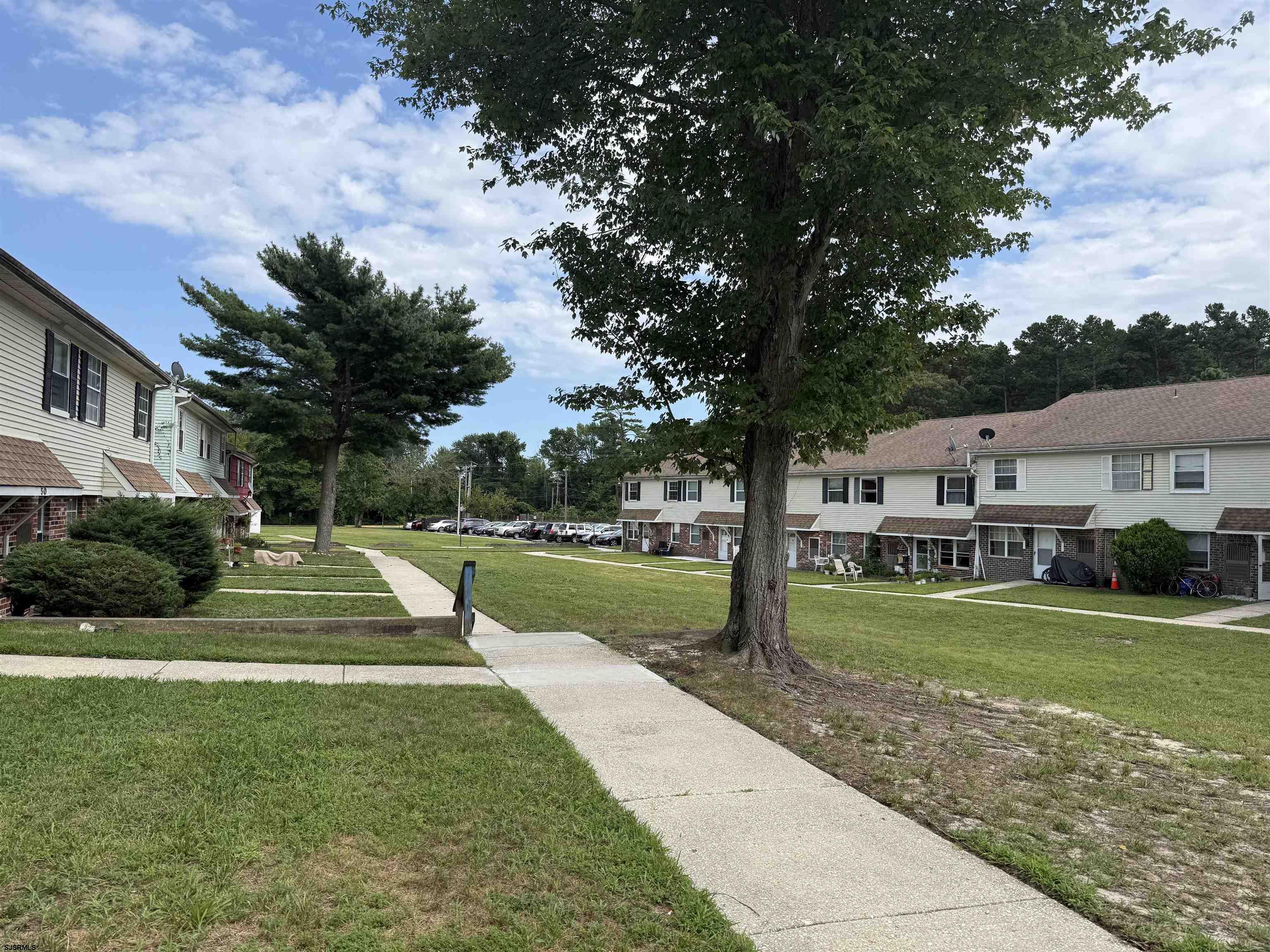 720 South New Road, Unit 5M Absecon, NJ 08201 - Photo 2 of 14 a view of a house with garden and a trees