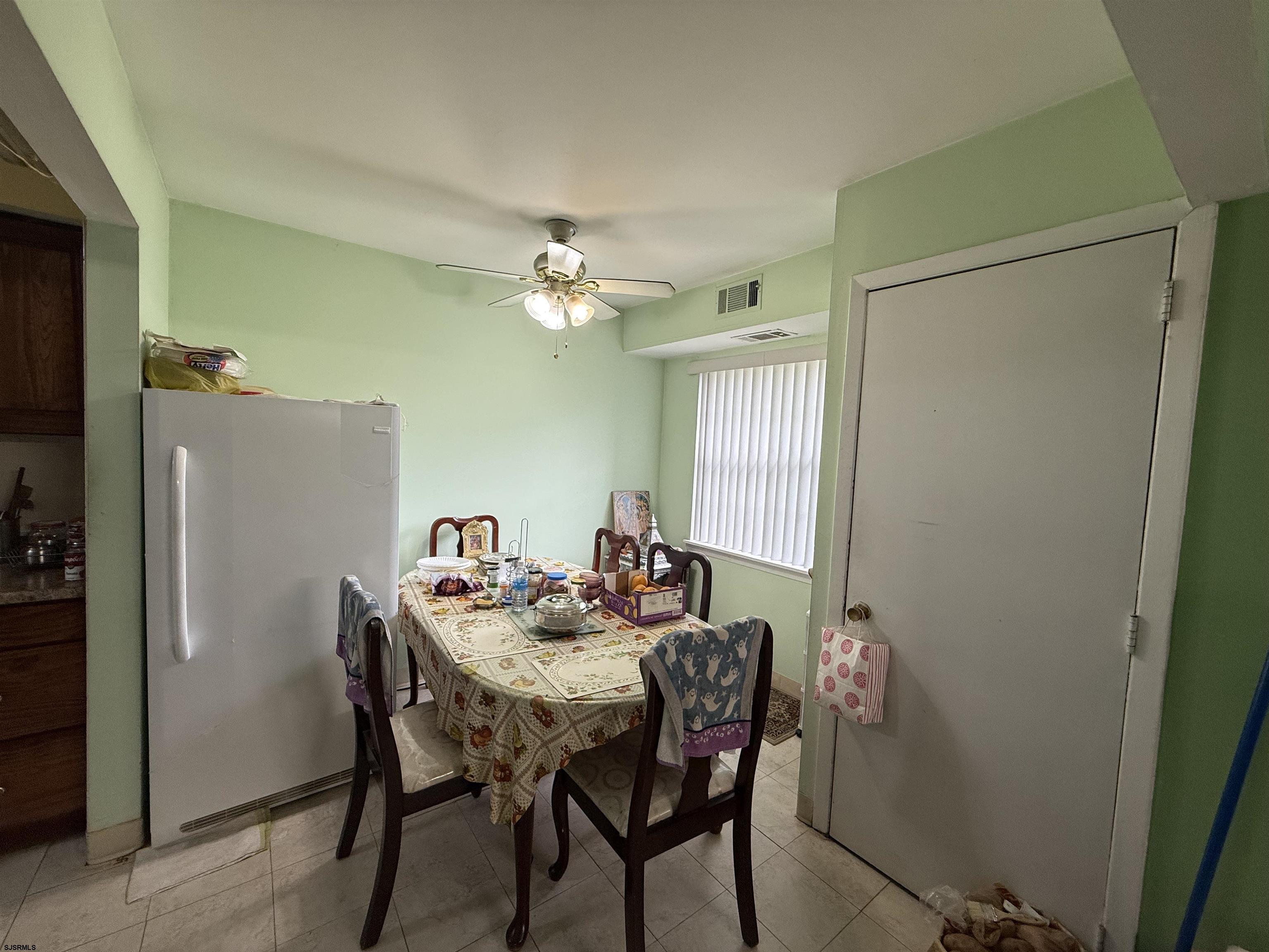 720 South New Road, Unit 5M Absecon, NJ 08201 - Photo 3 of 14 a view of a dining room with furniture and chandelier