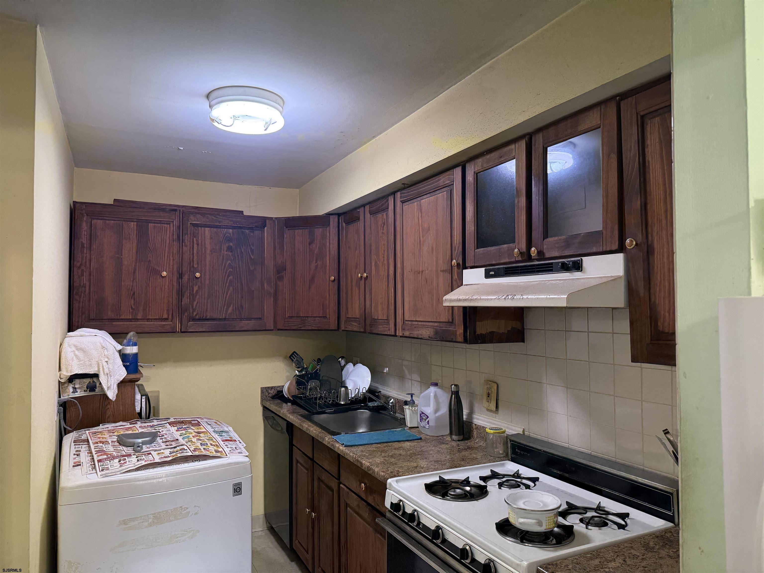 720 South New Road, Unit 5M Absecon, NJ 08201 - Photo 5 of 14 a kitchen with a stove a sink dishwasher and cabinets with wooden floor