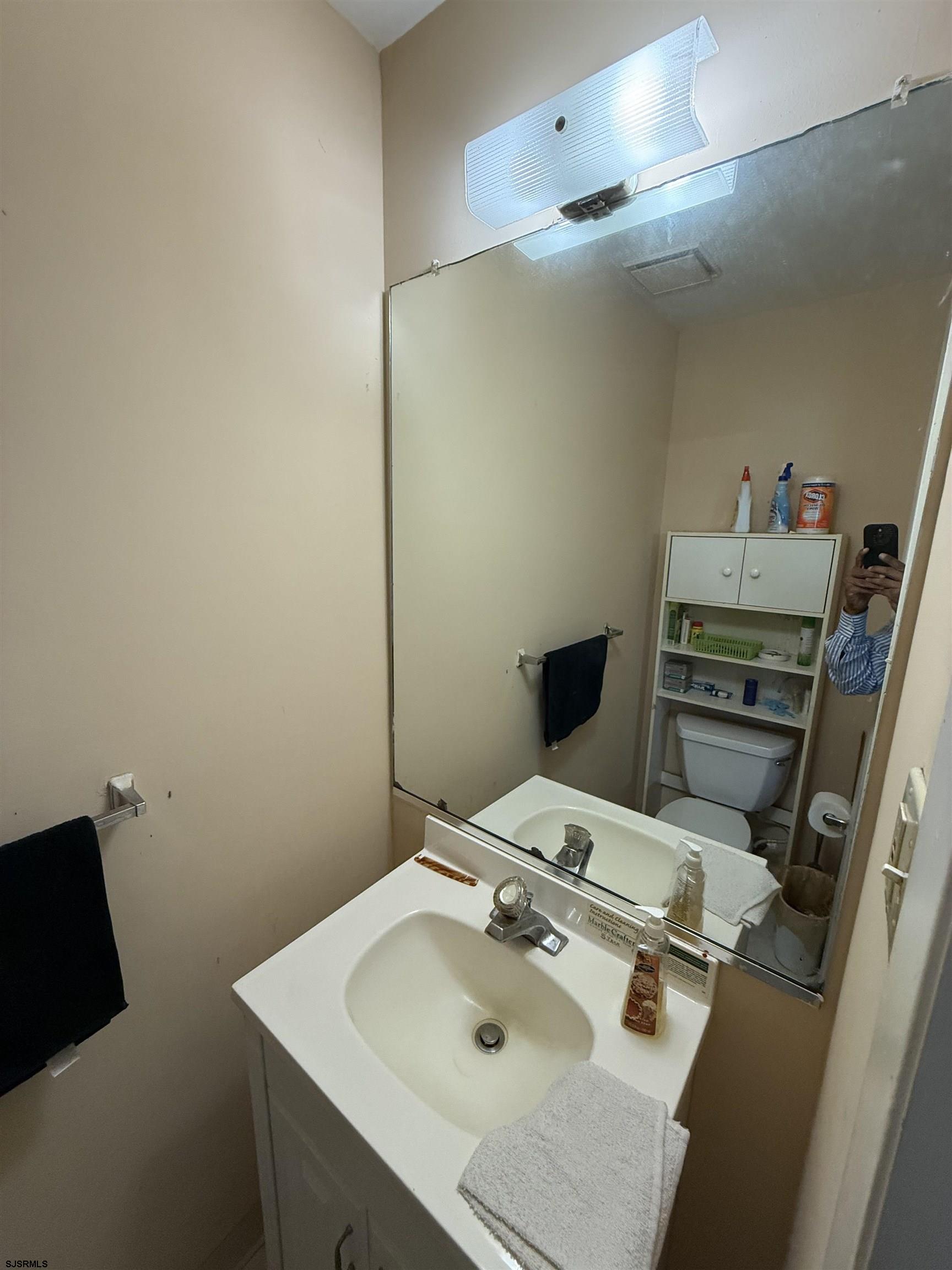 720 South New Road, Unit 5M Absecon, NJ 08201 - Photo 6 of 14 a bathroom with a sink and a mirror