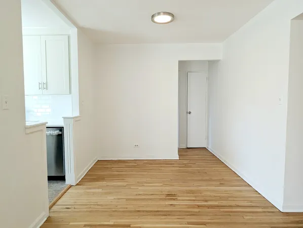 a view of a kitchen with wooden floor and electronic appliances