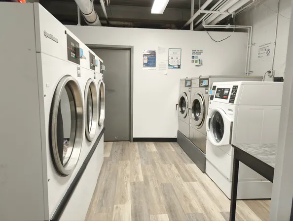 a view of washer and dryer with kitchen in the background