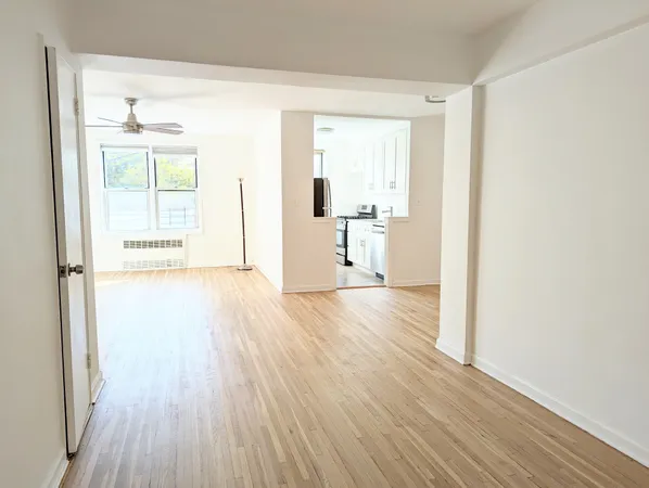 a view of a room with wooden floor ceiling fan