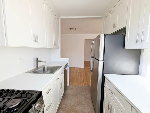 a kitchen with a refrigerator sink stove and cabinets