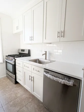 a kitchen with a sink stove and refrigerator