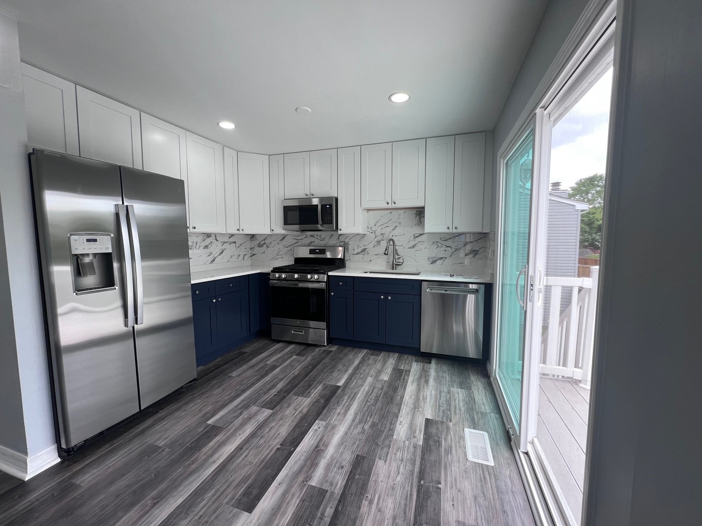 1170 Singleton Drive Roselle, IL 60172 - Photo 15 of 42 a kitchen with stainless steel appliances granite countertop a refrigerator a sink dishwasher a stove top oven a refrigerator and cabinets with wooden floor