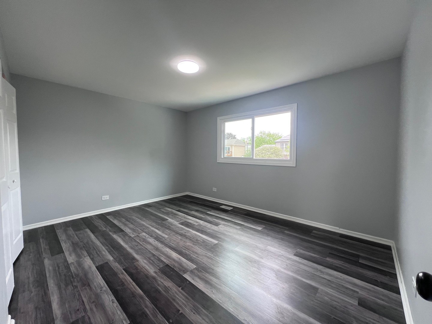 1170 Singleton Drive Roselle, IL 60172 - Photo 21 of 42 an empty room with wooden floor and windows