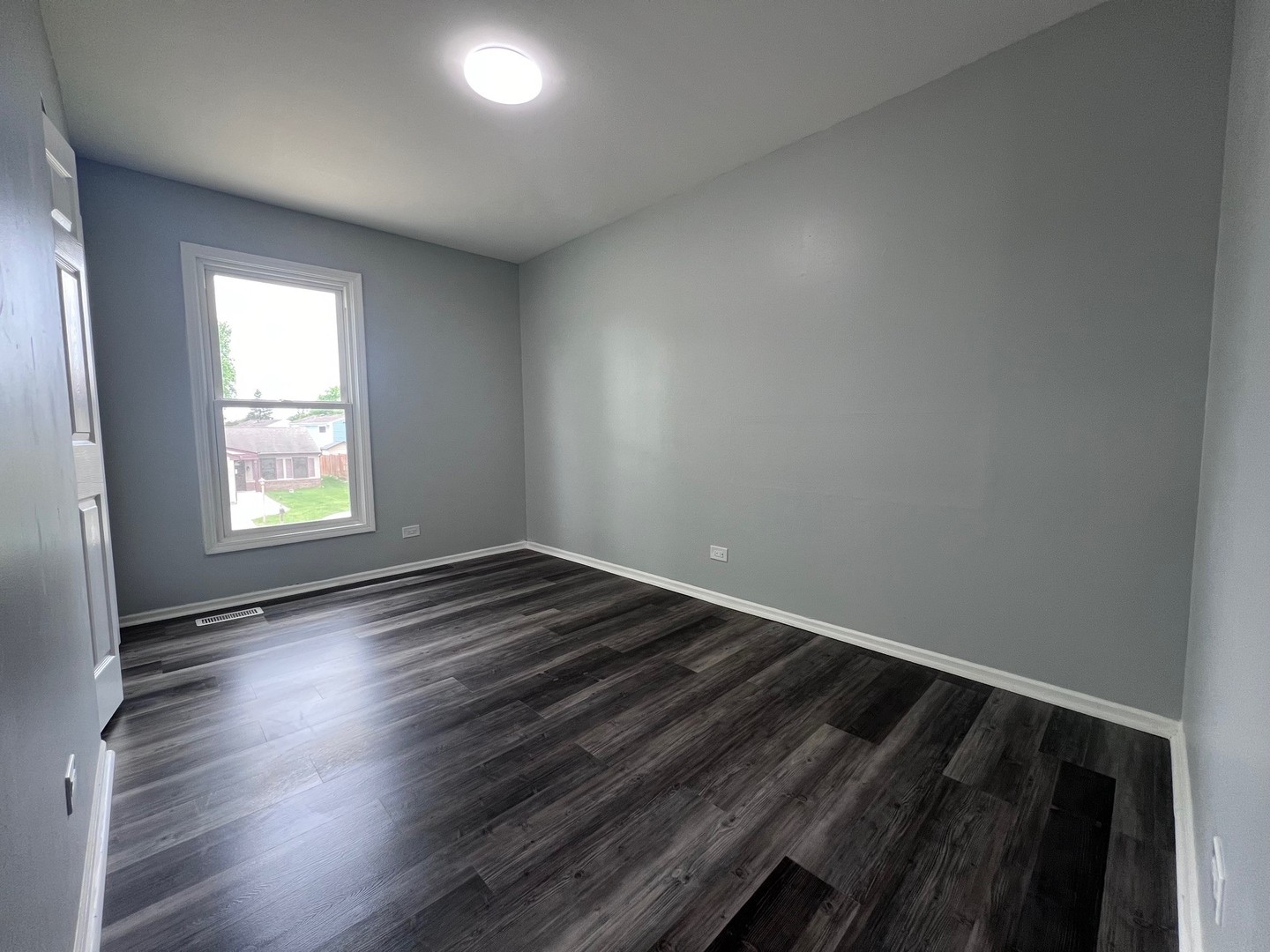 1170 Singleton Drive Roselle, IL 60172 - Photo 25 of 42 an empty room with wooden floor and windows
