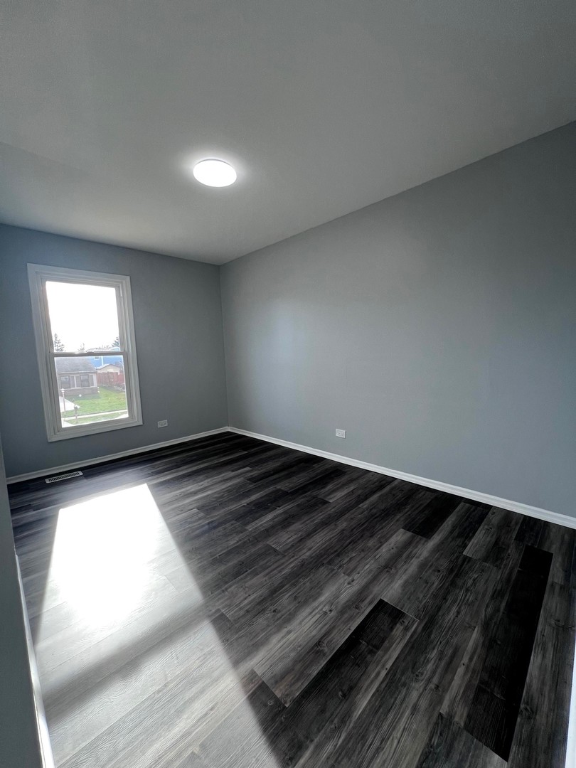 1170 Singleton Drive Roselle, IL 60172 - Photo 26 of 42 a view of wooden floor in an empty room