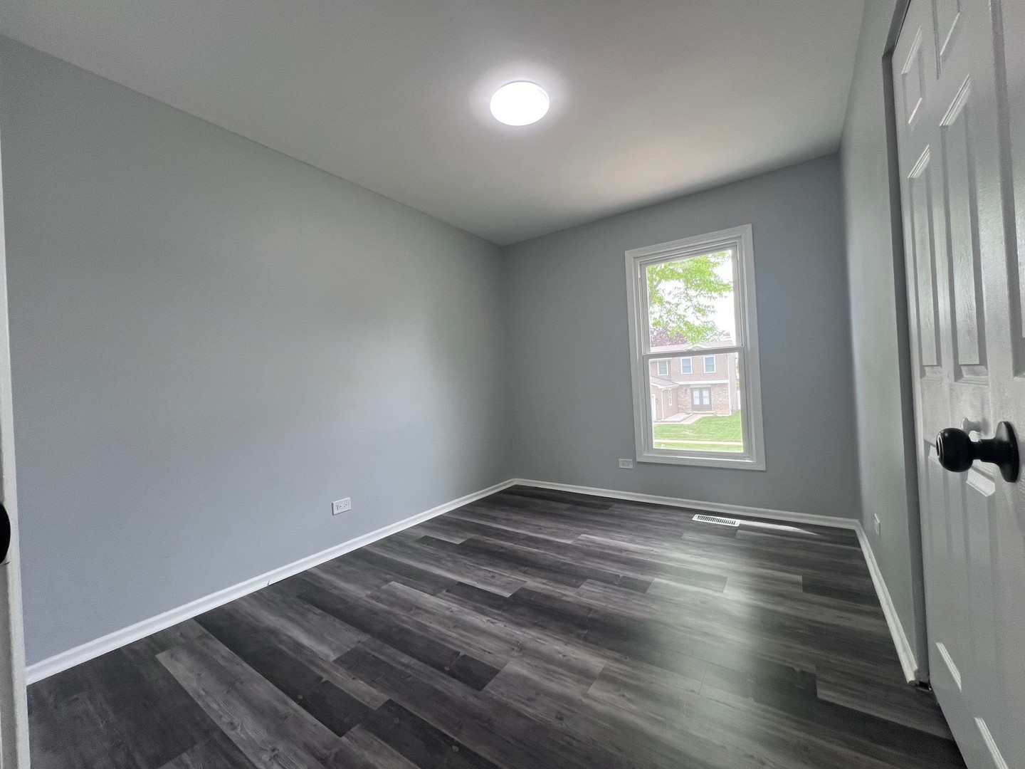 1170 Singleton Drive Roselle, IL 60172 - Photo 27 of 42 an empty room with wooden floor and windows