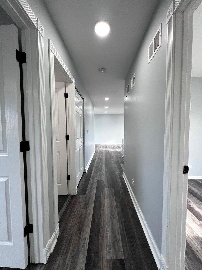 1170 Singleton Drive Roselle, IL 60172 - Photo 28 of 42 a view of hallway with wooden floor