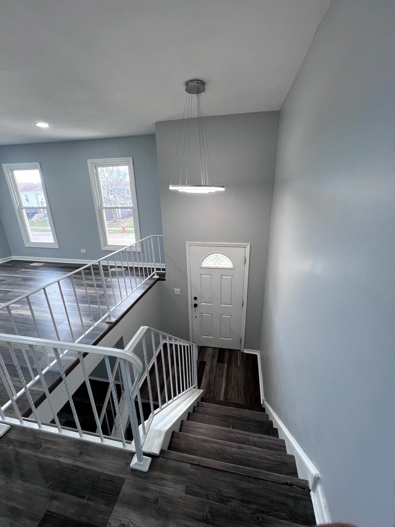 1170 Singleton Drive Roselle, IL 60172 - Photo 30 of 42 a view of entryway and hall with wooden floor
